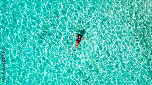 Drone Aerial of Pretty Girl Floating in Crystal Clear Blue Water at Beach In Tropical Paradise, Palawan, Philippines 2