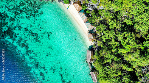 Drone Aerial of Pretty Girl Floating in Crystal Clear Blue Water at Beach In Tropical Paradise  Palawan  Philippines 4