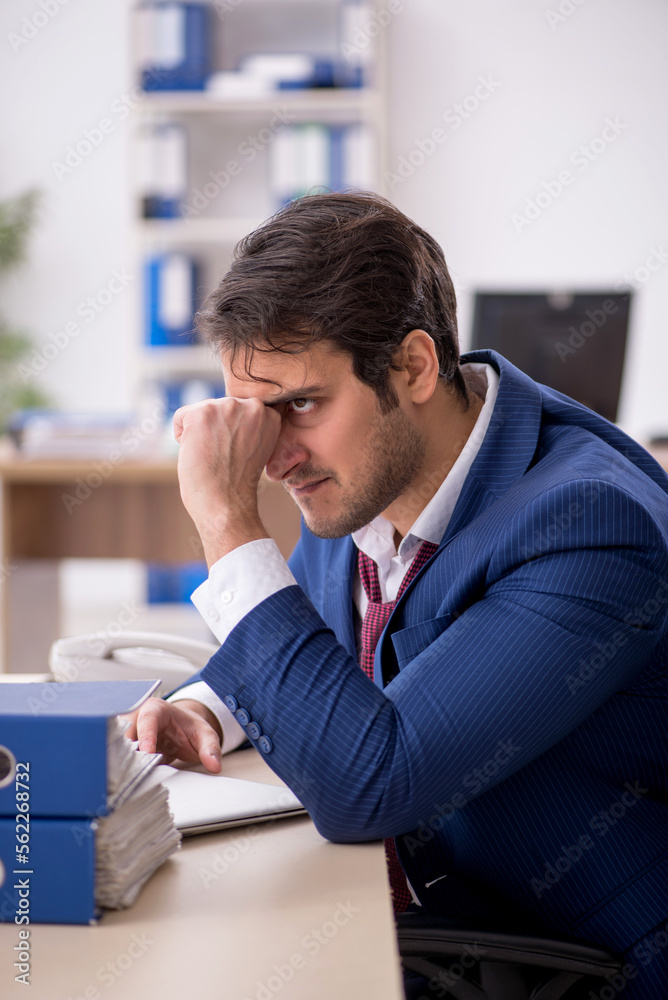 Young male employee working in the office Young male employee working in the office