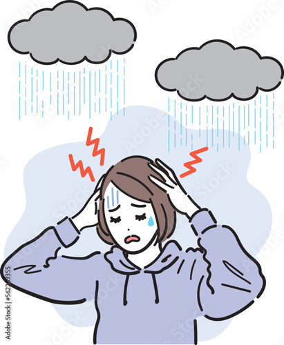 気象病による頭痛で悩んでいる女性