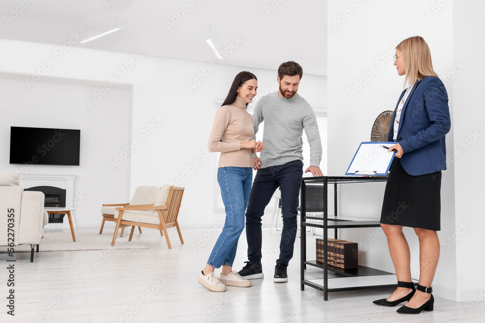 Real estate agent showing new apartment to couple Real estate agent showing new apartment to couple