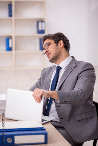 Young male employee working in the office