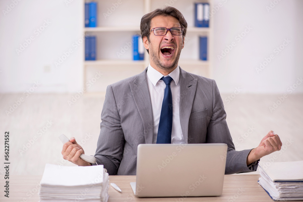 Young male employee working in the office Young male employee working in the office