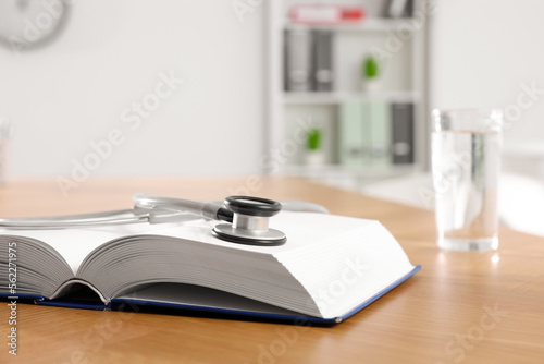 Wallpaper Mural Book and stethoscope on wooden table in clinic. Space for text Torontodigital.ca