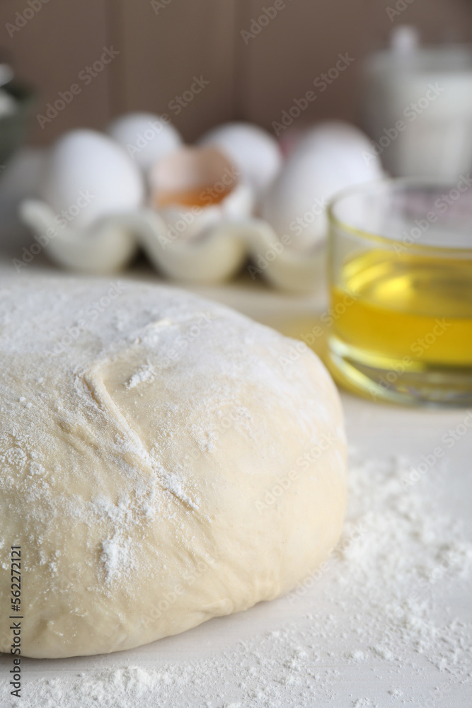 Fresh yeast dough with flour on white wooden table, closeup Fresh yeast dough with flour on white wooden table, closeup