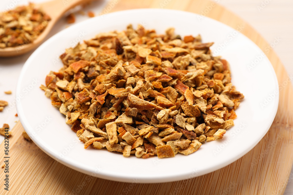 Plate with dried orange zest seasoning on plate, closeup Plate with dried orange zest seasoning on plate, closeup