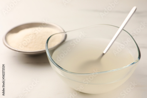 Agar-agar jelly and powder on white table, closeup