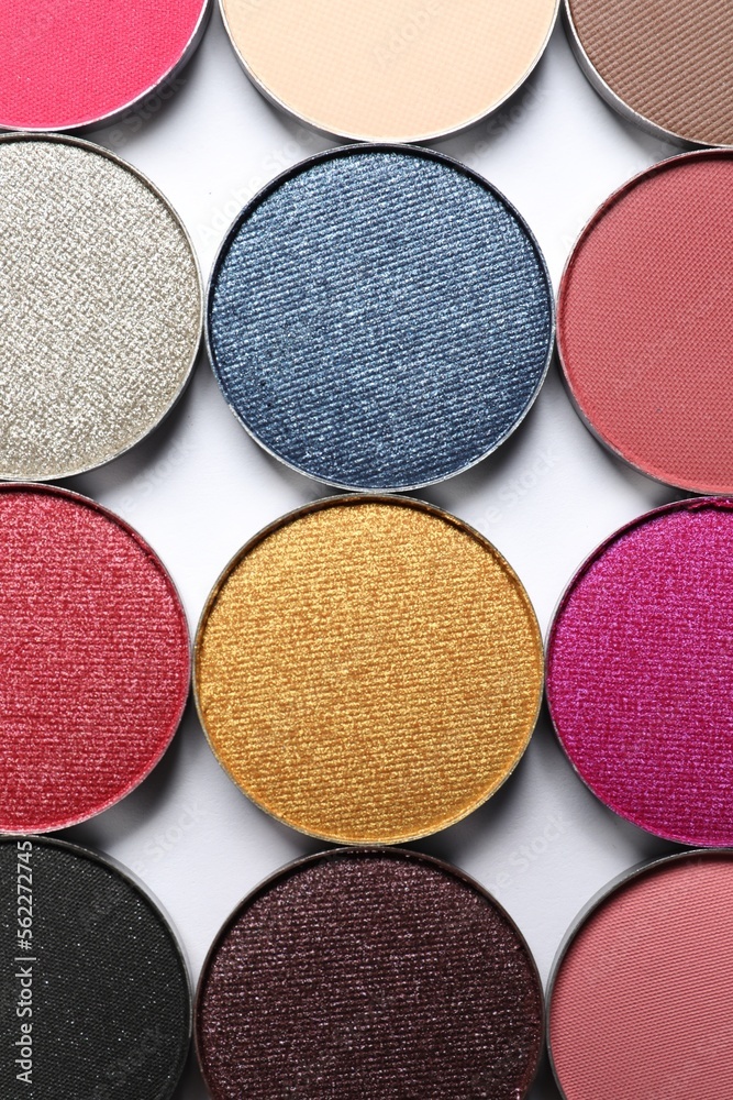 Fototapeta premium Different beautiful eye shadows on white background, flat lay