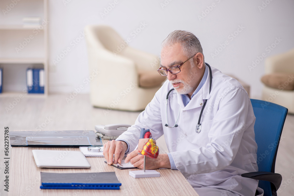Old male doctor cardiologist working at the hospital Old male doctor cardiologist working at the hospital