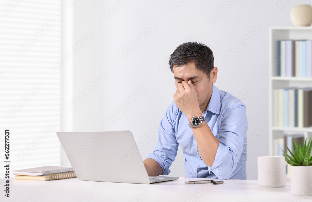 Overworked businessman eye strain after long laptop usage. Overworked businessman eye strain after long laptop usage.