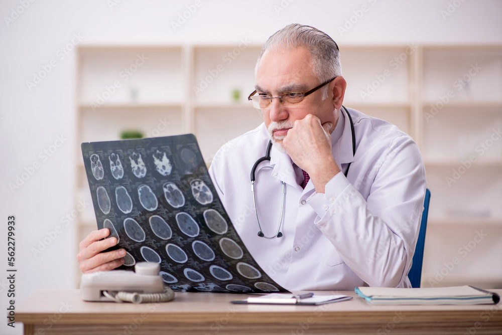 Old male doctor radiologist working in the clinic Old male doctor radiologist working in the clinic