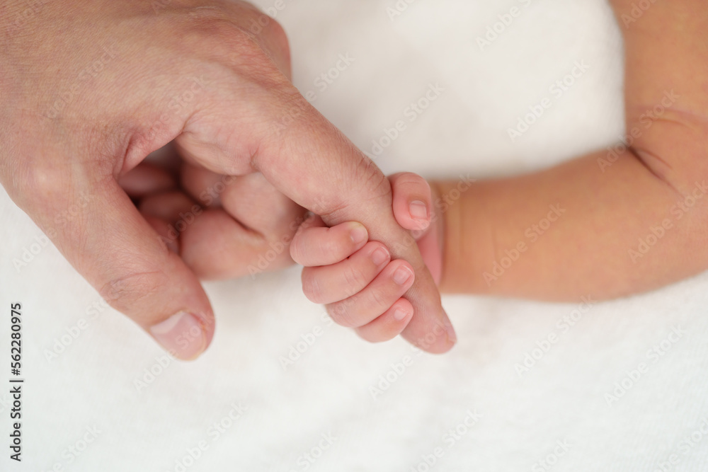 newborn baby hand holding index finger of mother on bed newborn baby hand holding index finger of mother on bed