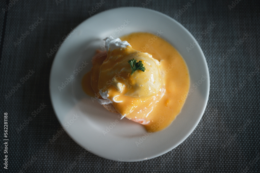 Delicious breakfast, egg benedict with smoked salmon on white dish Delicious breakfast, egg benedict with smoked salmon on white dish