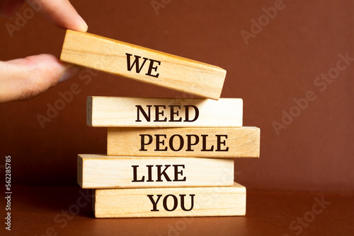 Wooden blocks with words 'We Need People Like You'.