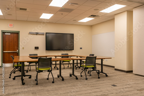 Obraz na plátně Interior of an office training, meeting, conference room with desks, chairs, and white board