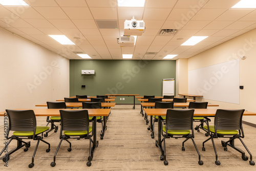 Obraz na plátně Interior of an office training, meeting, conference room with desks, chairs, and white board