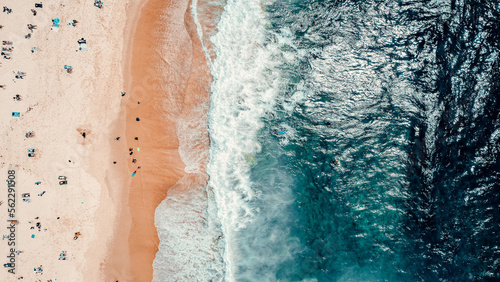 Aerial Drone Overhead Shot of Beach With People, Blue Water, Waves Crashing Onto Beach, Sunny photo