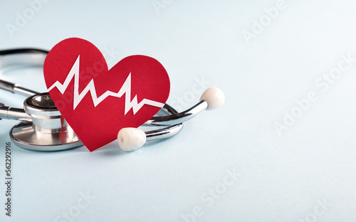 Heart health and Cardiology concept. Red heart with cardiogram chart line and medical stethoscope on pastel blue background. Closeup, copy space, banner