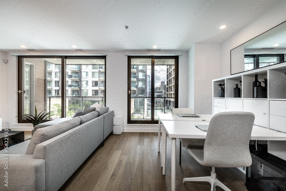 Fototapeta premium Luxury modern apartment in condominium in Montreal perfectly staged and furnished with amentinites common areas swimming pool, rooftop, terrace, gym, garden and city views