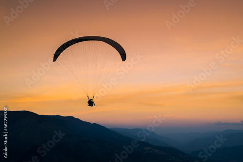 Paraglider silhouette at sunset