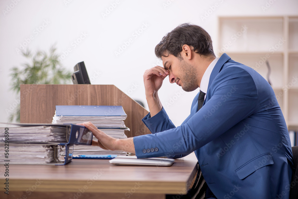 Young male employee working in the office Young male employee working in the office