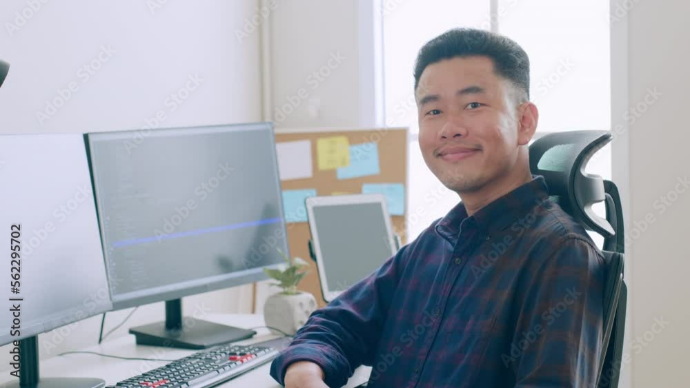 Portrait young Asian man developer programmer, software engineer, IT support, look at camera and smile enjoy working at office.