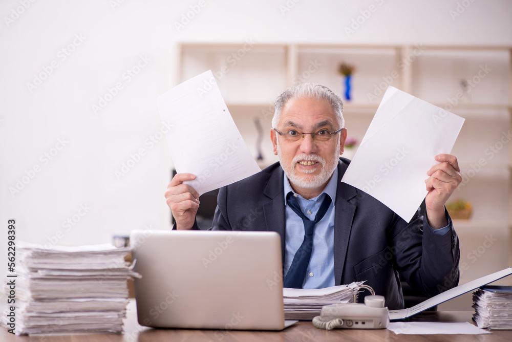 Old male employee and too much work in the office Old male employee and too much work in the office