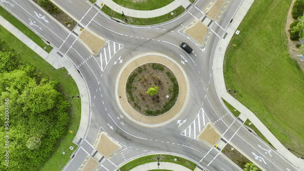 Aerial view of road roundabout intersection with moving cars traffic. Rural circular transportation crossroads Aerial view of road roundabout intersection with moving cars traffic. Rural circular transportation crossroads
