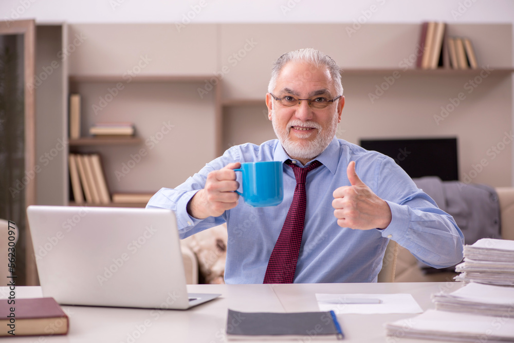 Old male employee working from home during pandemic Old male employee working from home during pandemic