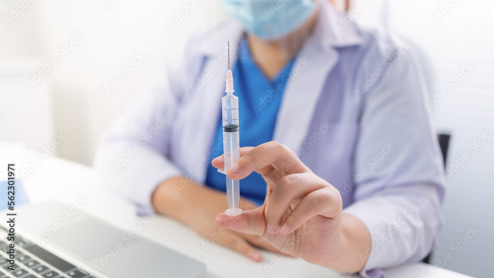 Professional medical asian woman doctor with Syringe medical injection in hand vaccine injecting health drug vaccination influenza Professional medical asian woman doctor with Syringe medical injection in hand vaccine injecting health drug vaccination influenza