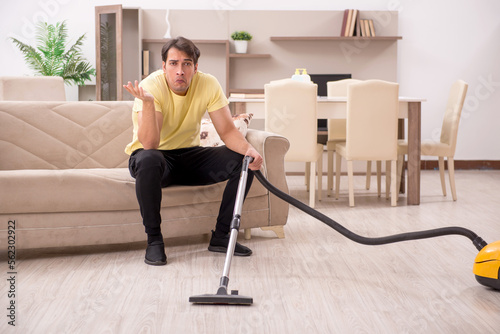 Young man doing housework indoors