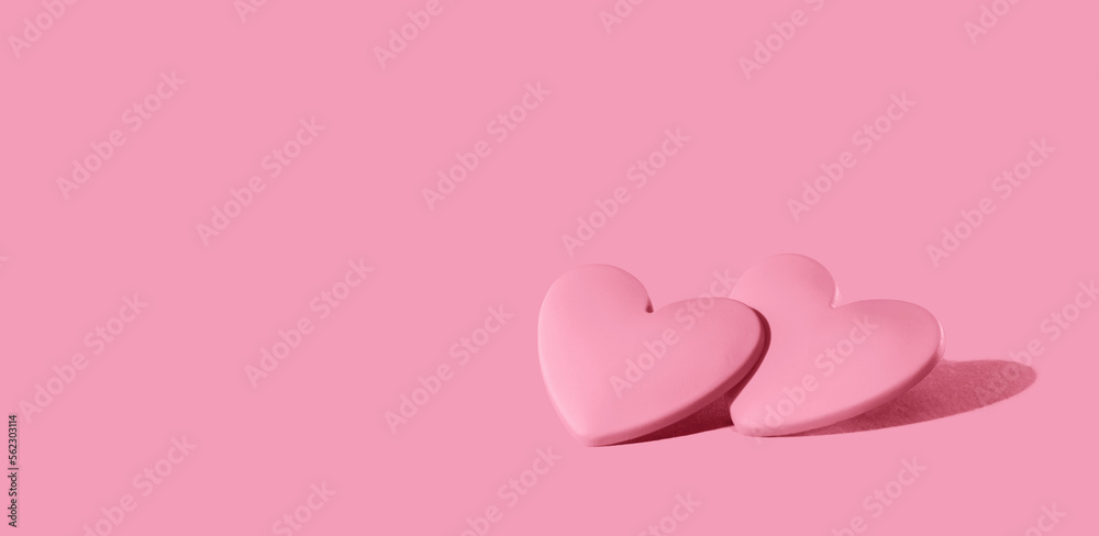 two pink hearts on pink background. Minimal monochrome for St Valentines day or 14 February. Mothers Day or wedding invitation - obrazy, fototapety, plakaty 