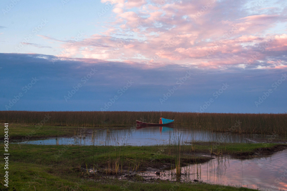 Fototapeta premium sunset over the lake whit boat