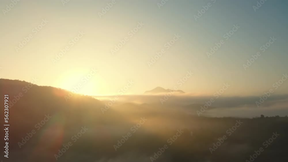 Aerial view over the Sea clouds in the valley with sunrise shinning pass through the mountain edge at Mae Hong Son, amazing Thailand. Unseen Scenic landscape in Thailand. Aerial view over the Sea clouds in the valley with sunrise shinning pass through the mountain edge at Mae Hong Son, amazing Thailand. Unseen Scenic landscape in Thailand.