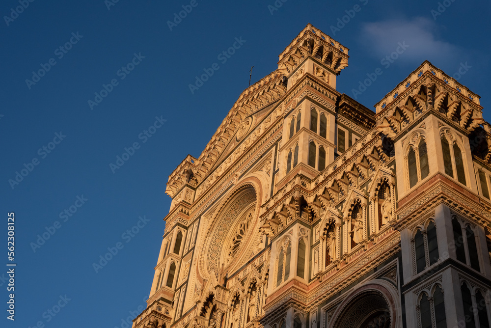 Part of the facade of an ancient building Duomo in Florence, sunset, close up.