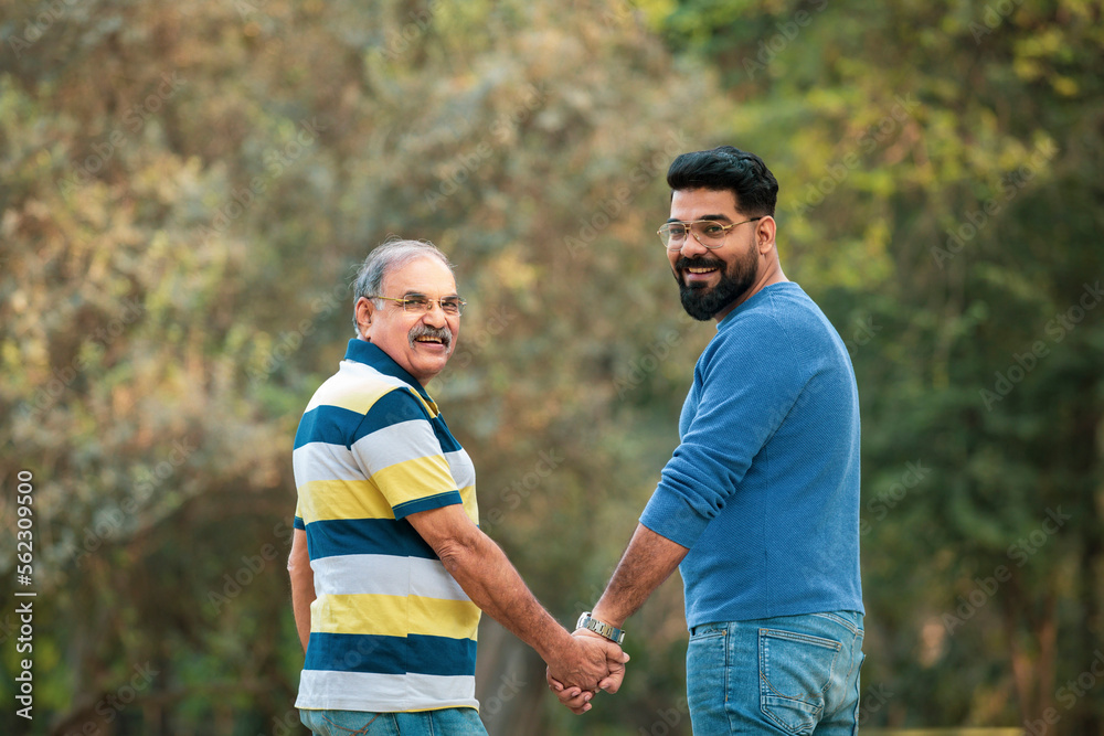 Old indian father with his young son spending time at park. Old indian father with his young son spending time at park.