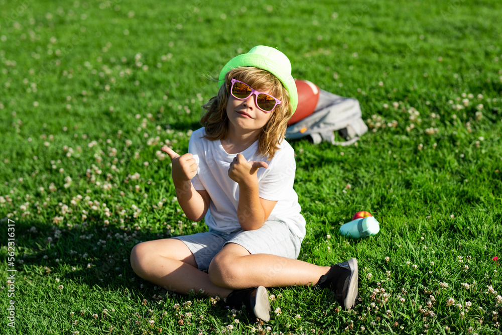 Fototapeta premium Happy childhood lifestyle. Outdoor summer backyard activity for kids. Kids playing outdoors in summer park. Freedom and carefree. Happy childhood. Relaxing kid in green field during summer.