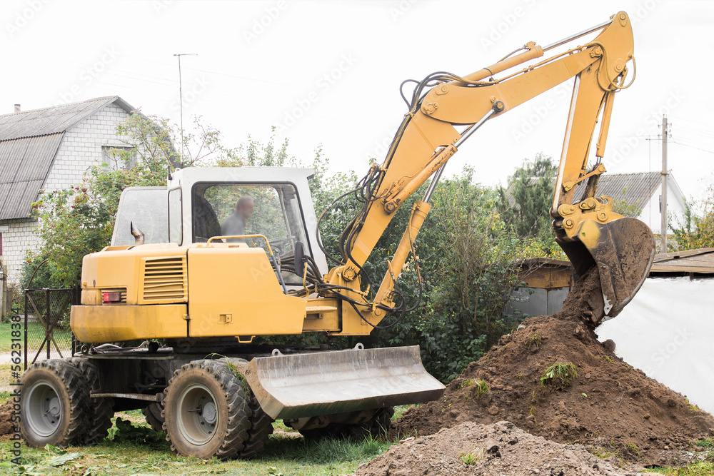 A bulldozer is digging on outdoors in an industrial area. Excavation