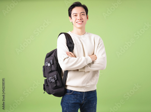 Image of young Asian student on background