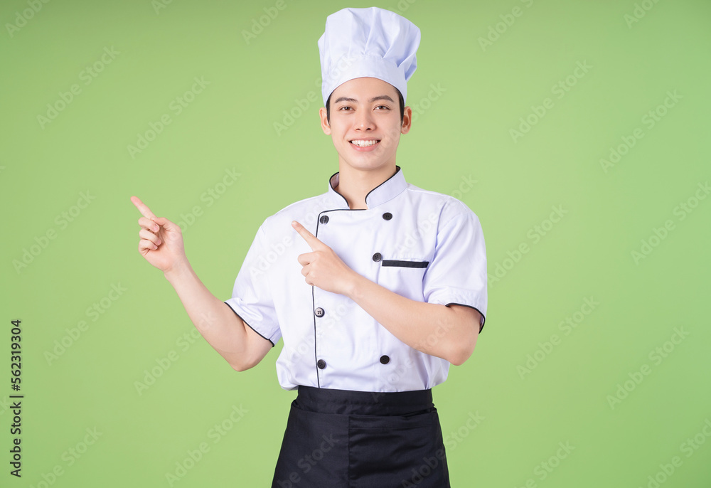 Photo of young Asian male chef on background Photo of young Asian male chef on background