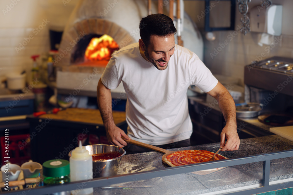 Pizza chef working in the kitchen Pizza chef working in the kitchen