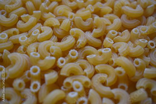 Background from macaroni pipa rigata. Raw, uncooked. Top view, close-up.