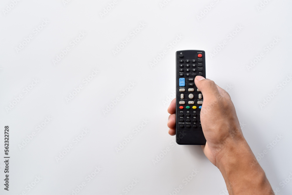 Hand holding television remote control isolated on white background Hand holding television remote control isolated on white background