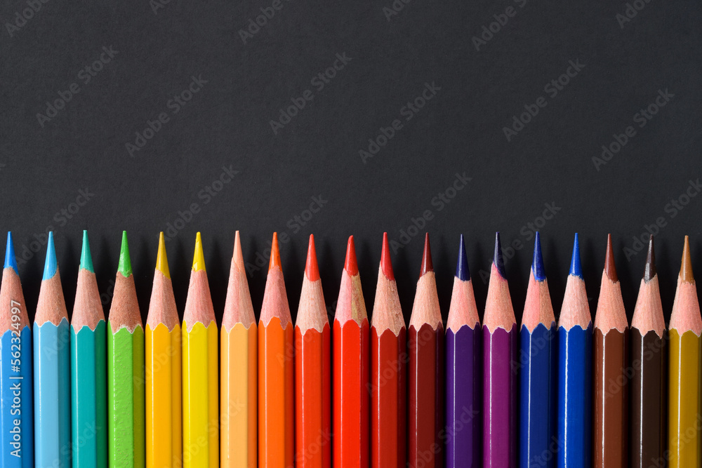 Color pencils with copy space isolated on black paper. Close up Color pencils with copy space isolated on black paper. Close up