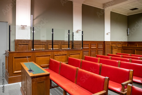 Courtroom interior court defendant box with red benches for defense and spectator