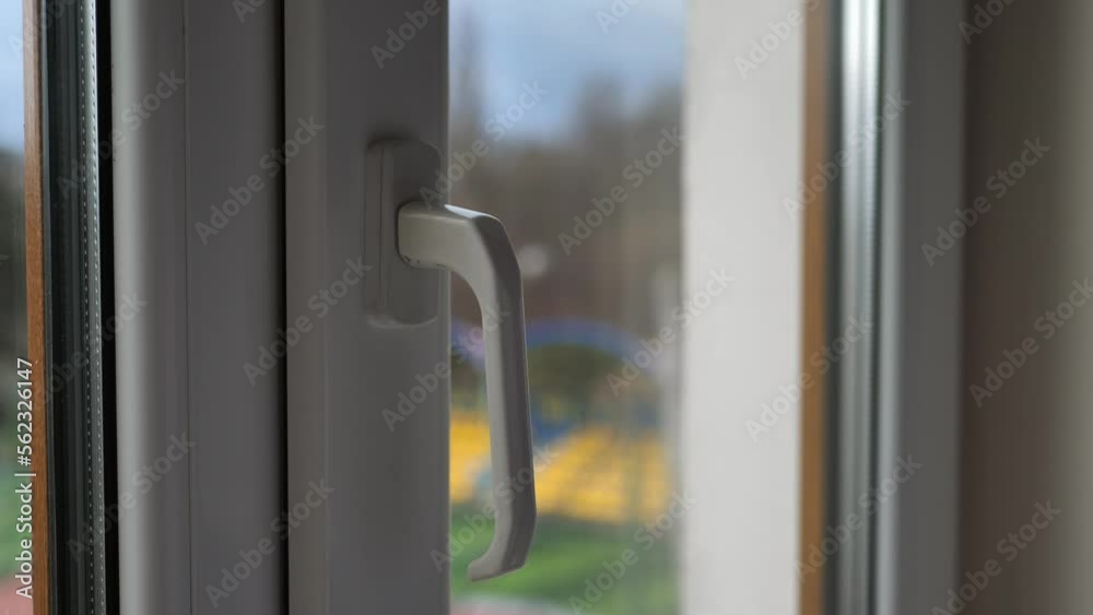Businessman's hand closes a large window in the office Businessman's hand closes a large window in the office