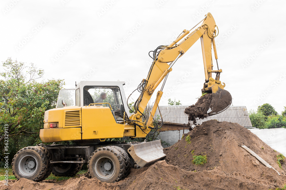 A excavator is digging on outdoors in an industrial site. Excavation works
