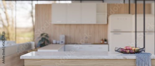 Empty space on white marble kitchen tabletop over blurred modern minimal kitchen in background