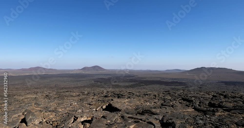 Views across the black lava volcano field of Jabal Qidr in the Harrat Khaybar region, north west Saudi Arabia photo