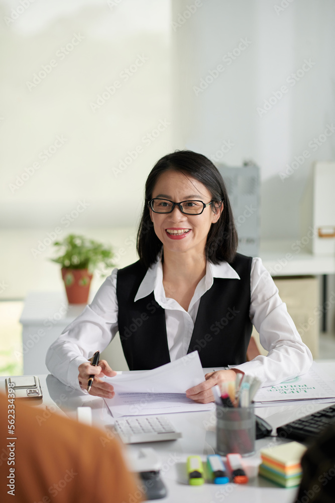 Smiling insurance agent talking to clients and offering life insurance policy Smiling insurance agent talking to clients and offering life insurance policy